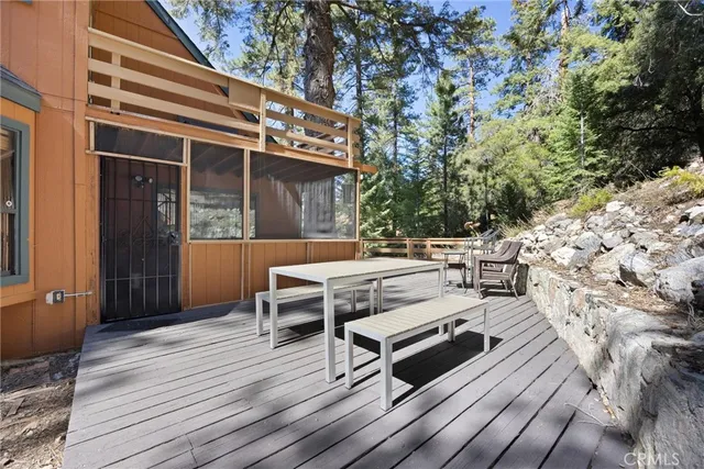 a view of a balcony with wooden floor and outdoor space
