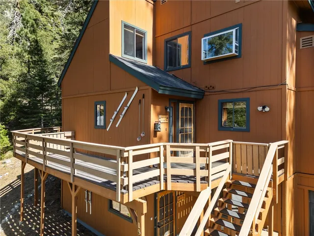a view of a blue house with iron stairs