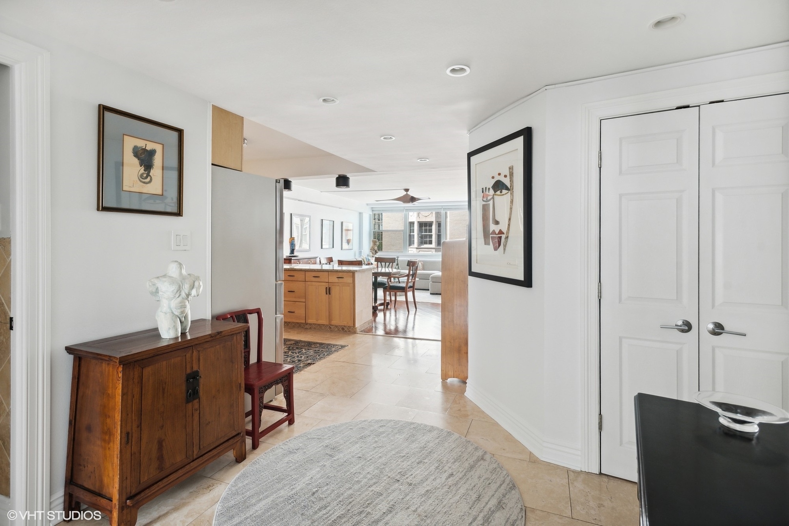 1150 North Lake Shore Drive, Unit 4H Chicago, IL 60611 - Photo 2 of 18 a living room with stainless steel appliances kitchen island granite countertop furniture and a refrigerator