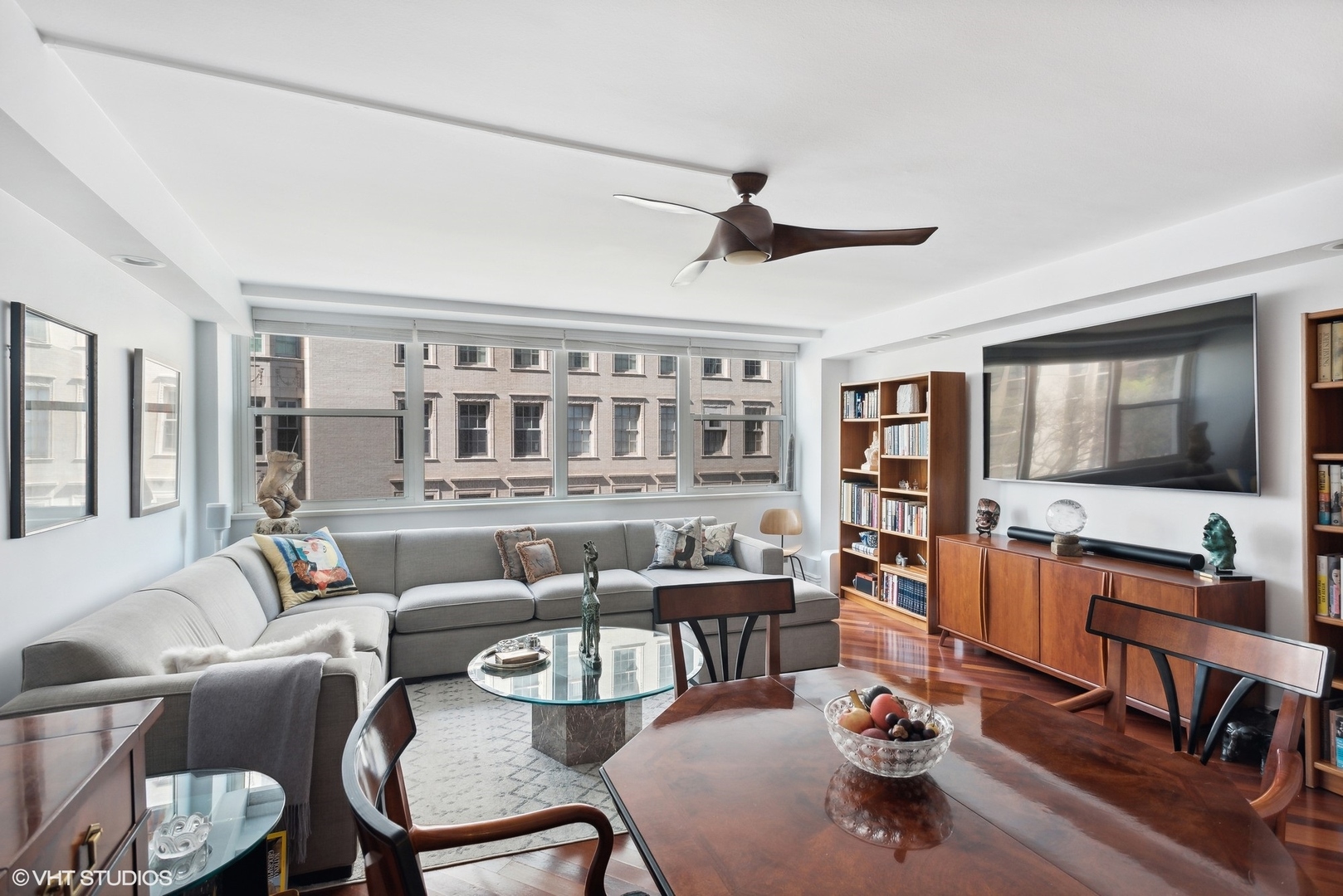 1150 North Lake Shore Drive, Unit 4H Chicago, IL 60611 - Photo 3 of 18 a living room with furniture and a flat screen tv