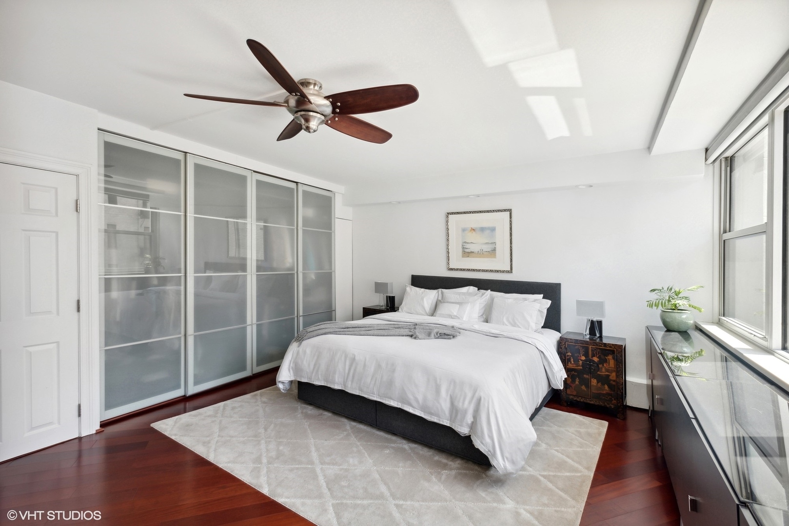 1150 North Lake Shore Drive, Unit 4H Chicago, IL 60611 - Photo 10 of 18 a spacious bedroom with a bed and a glass door