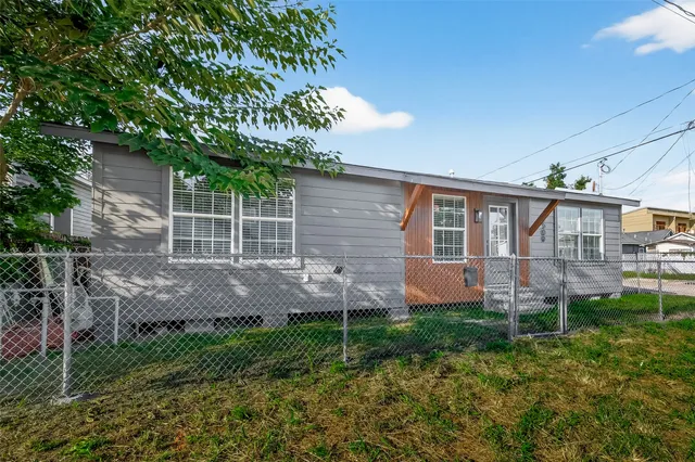 a view of a house with a yard and sitting area