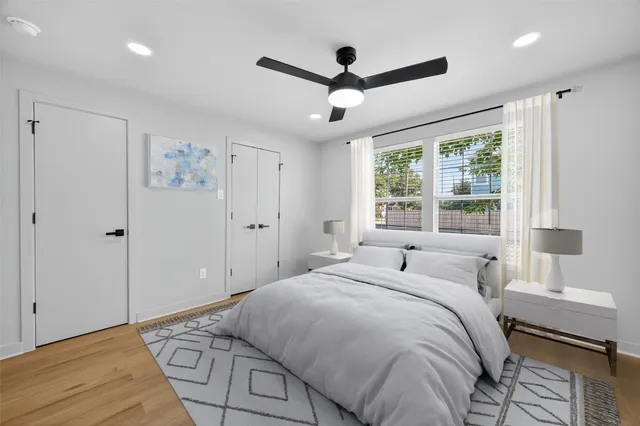 a bedroom with a large bed and a window