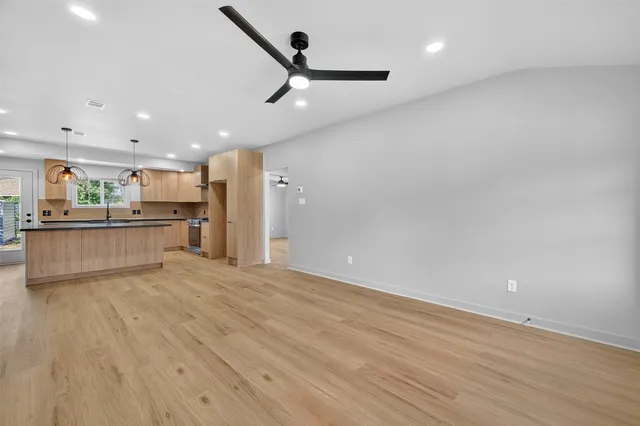 a view of a kitchen with a sink and a refrigerator