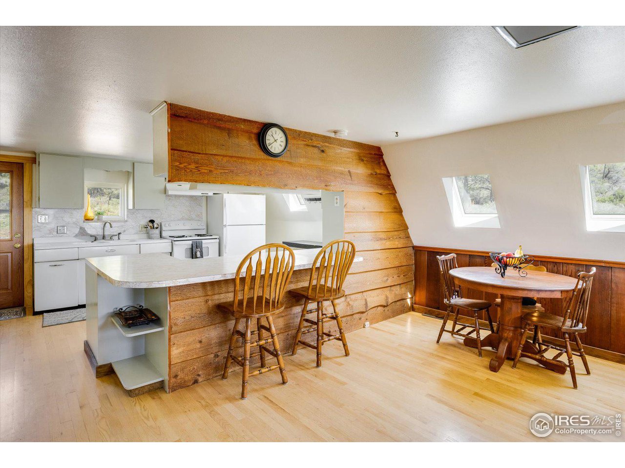 5690 Sugarloaf Road Boulder, CO 80302 - Photo 12 of 27 a living room with dining room and wooden floor
