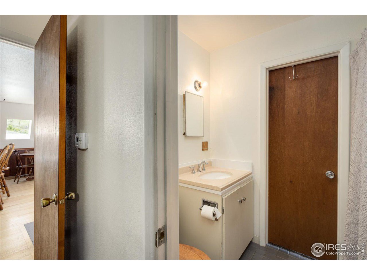 5690 Sugarloaf Road Boulder, CO 80302 - Photo 17 of 27 a bathroom with a sink a mirror and a shower
