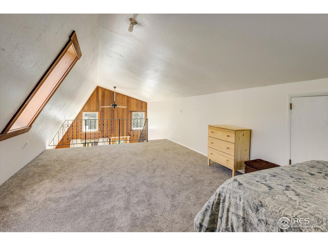 5690 Sugarloaf Road Boulder, CO 80302 - Photo 19 of 27 a bedroom with a bed and a large mirror