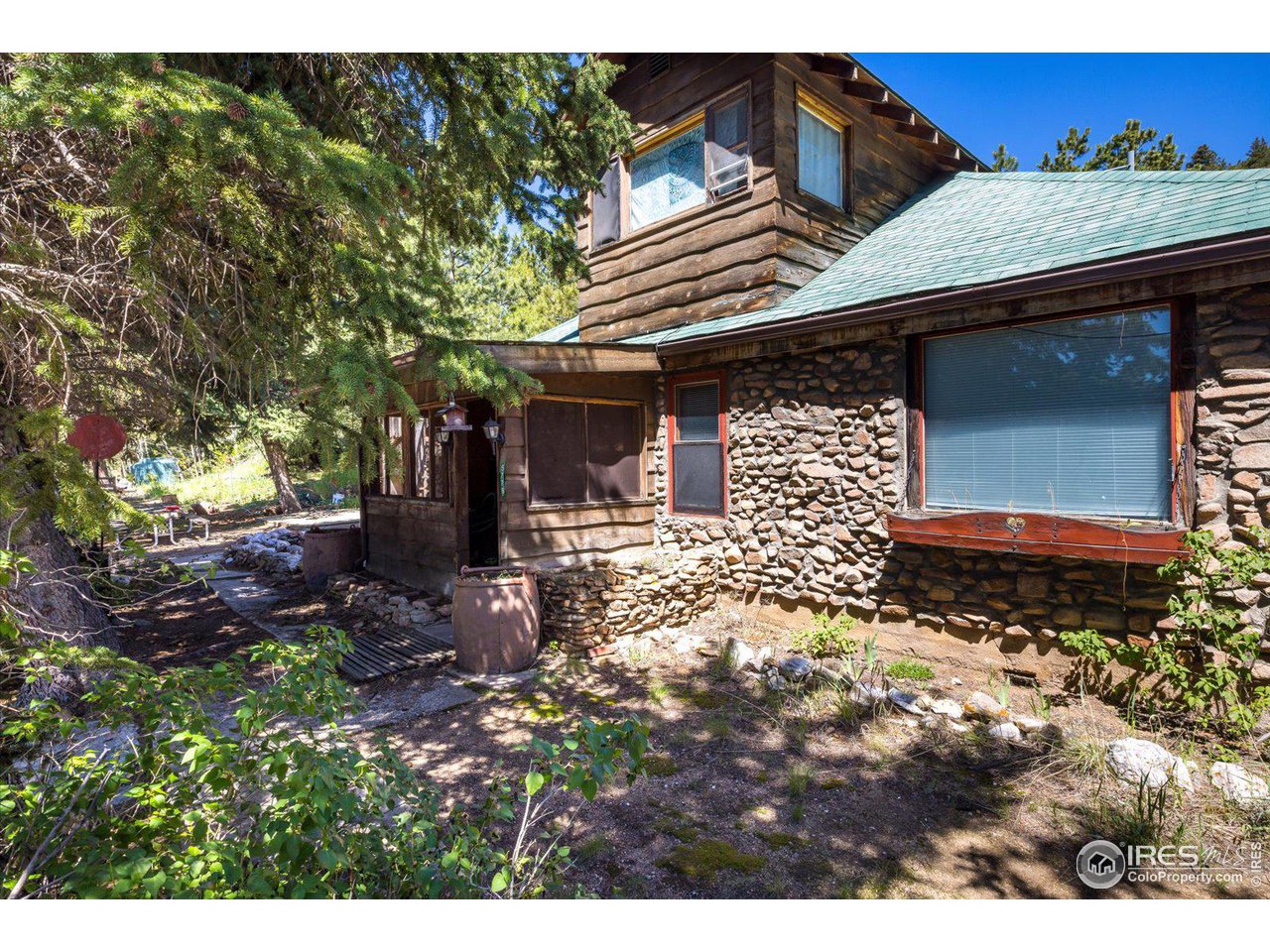 5690 Sugarloaf Road Boulder, CO 80302 - Photo 22 of 27 a front view of a house with a yard