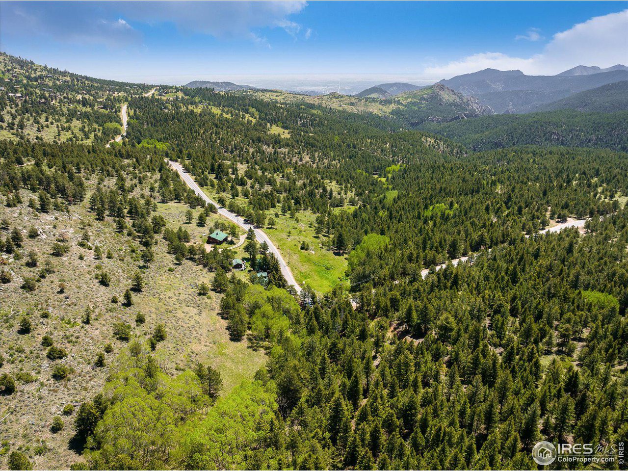 5690 Sugarloaf Road Boulder, CO 80302 - Photo 26 of 27 a view of a lush green hillside and a mountain