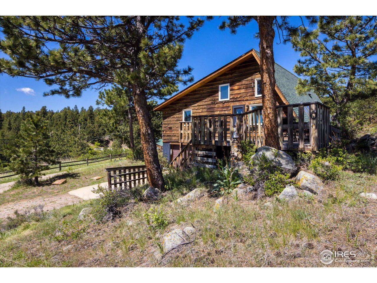 5690 Sugarloaf Road Boulder, CO 80302 - Photo 4 of 27 a front view of a house with a yard