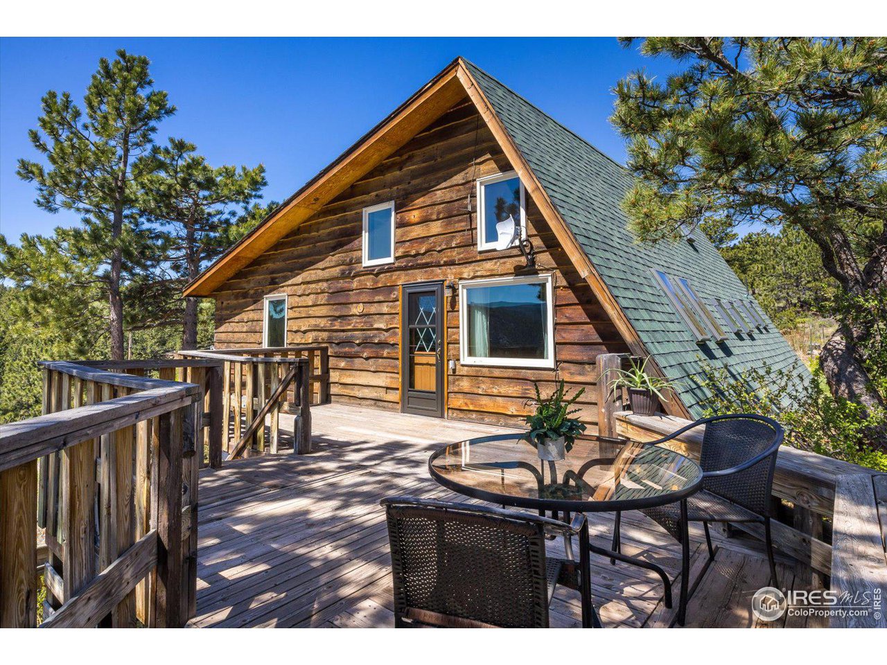 5690 Sugarloaf Road Boulder, CO 80302 - Photo 5 of 27 a backyard of a house with table and chairs