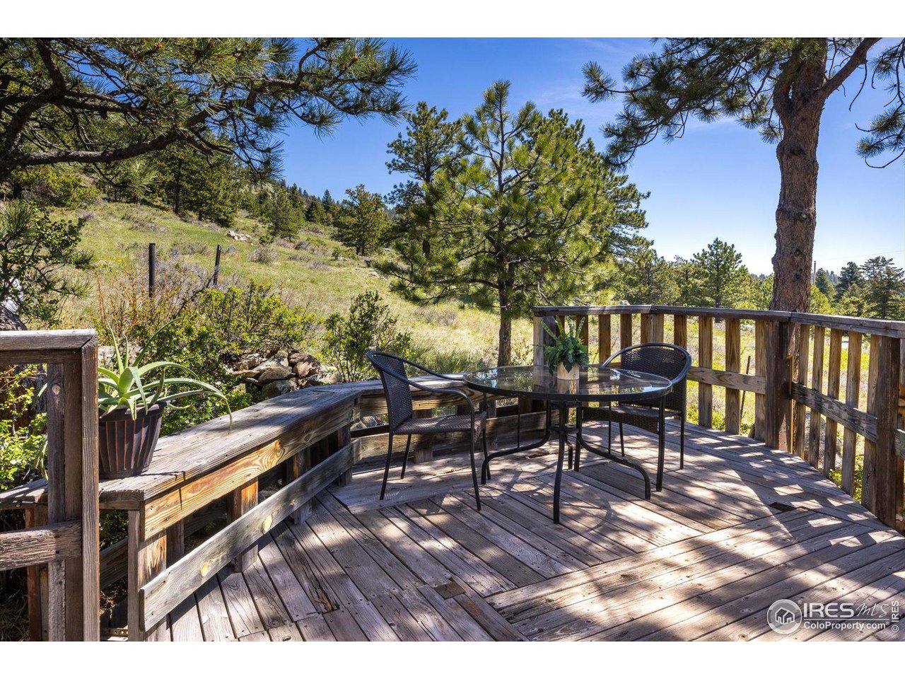 5690 Sugarloaf Road Boulder, CO 80302 - Photo 6 of 27 a view of a chairs and table on the wooden floor
