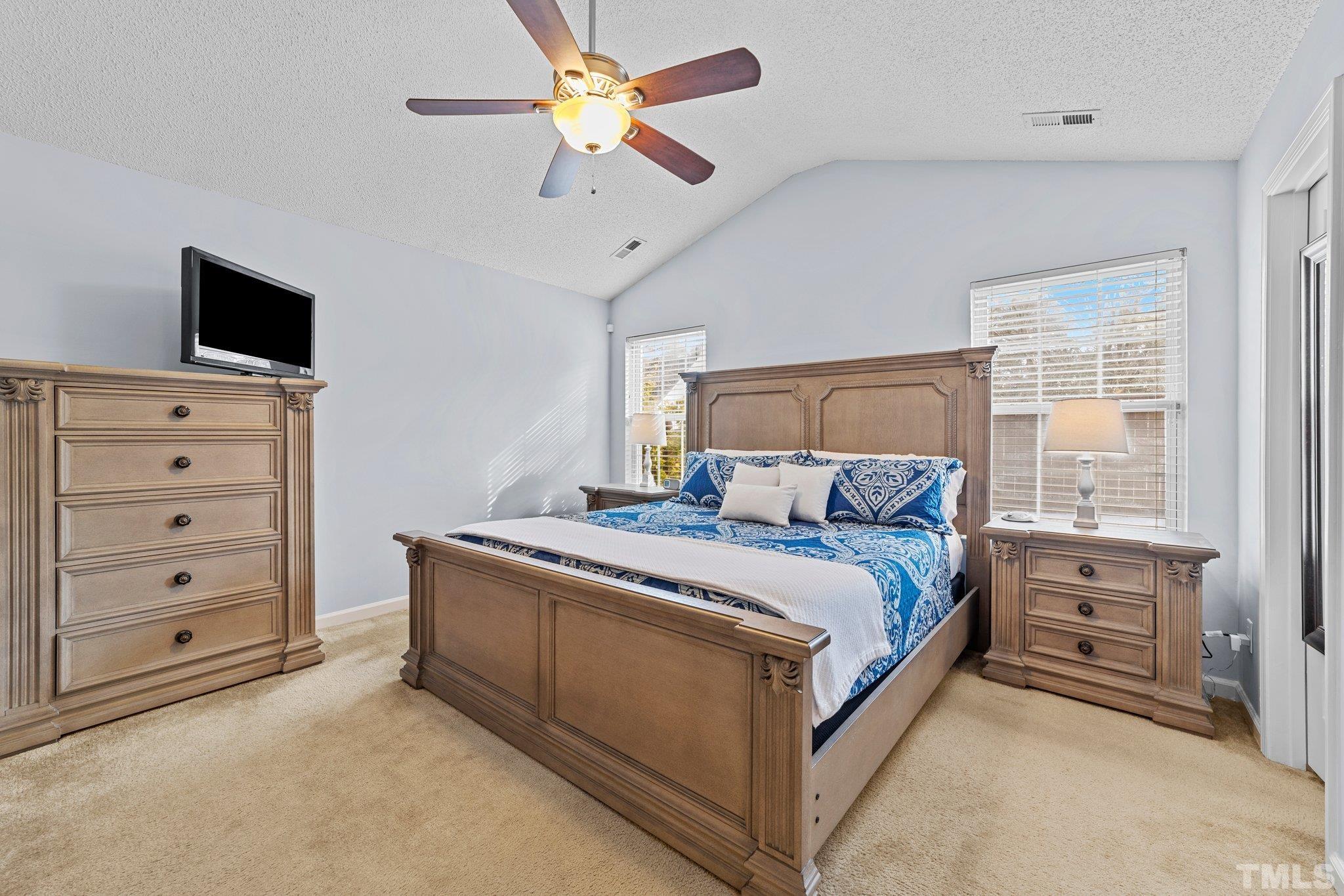 5022 Silhouette Drive Durham, NC 27713 - Photo 13 of 26 a bed room with a bed and a television