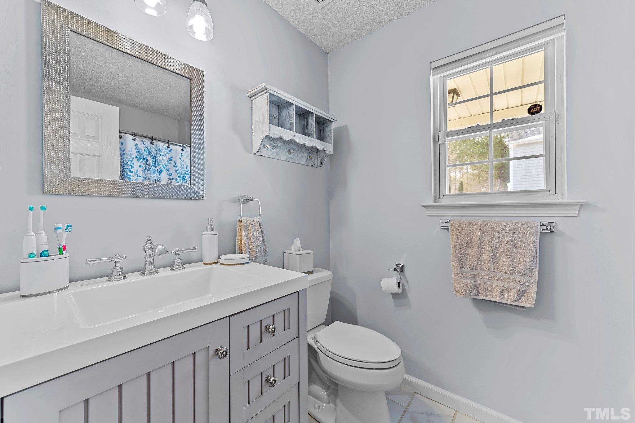 5022 Silhouette Drive Durham, NC 27713 - Photo 14 of 26 a bathroom with a sink and a toilet