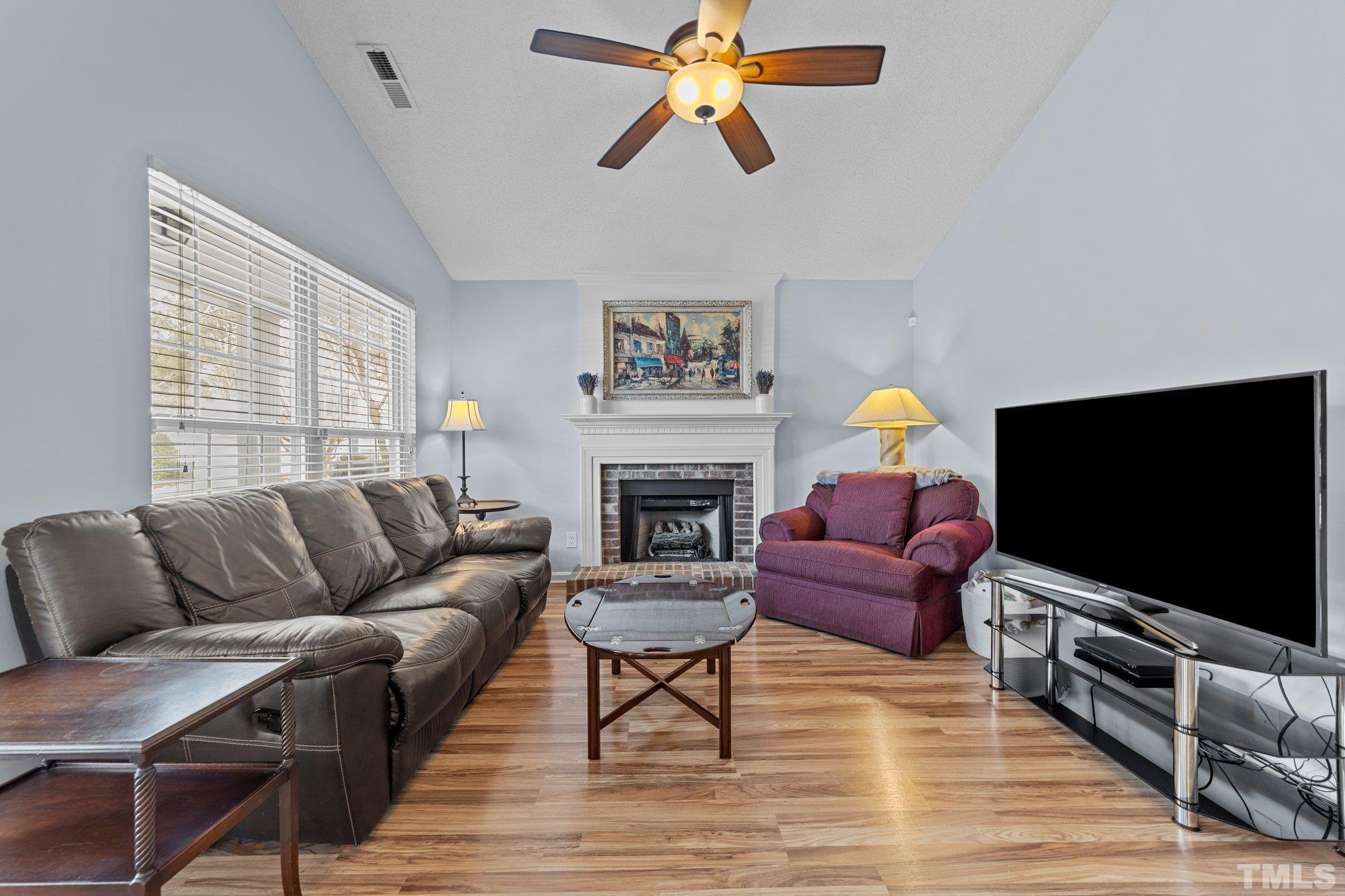 5022 Silhouette Drive Durham, NC 27713 - Photo 3 of 26 a living room with furniture and a flat screen tv