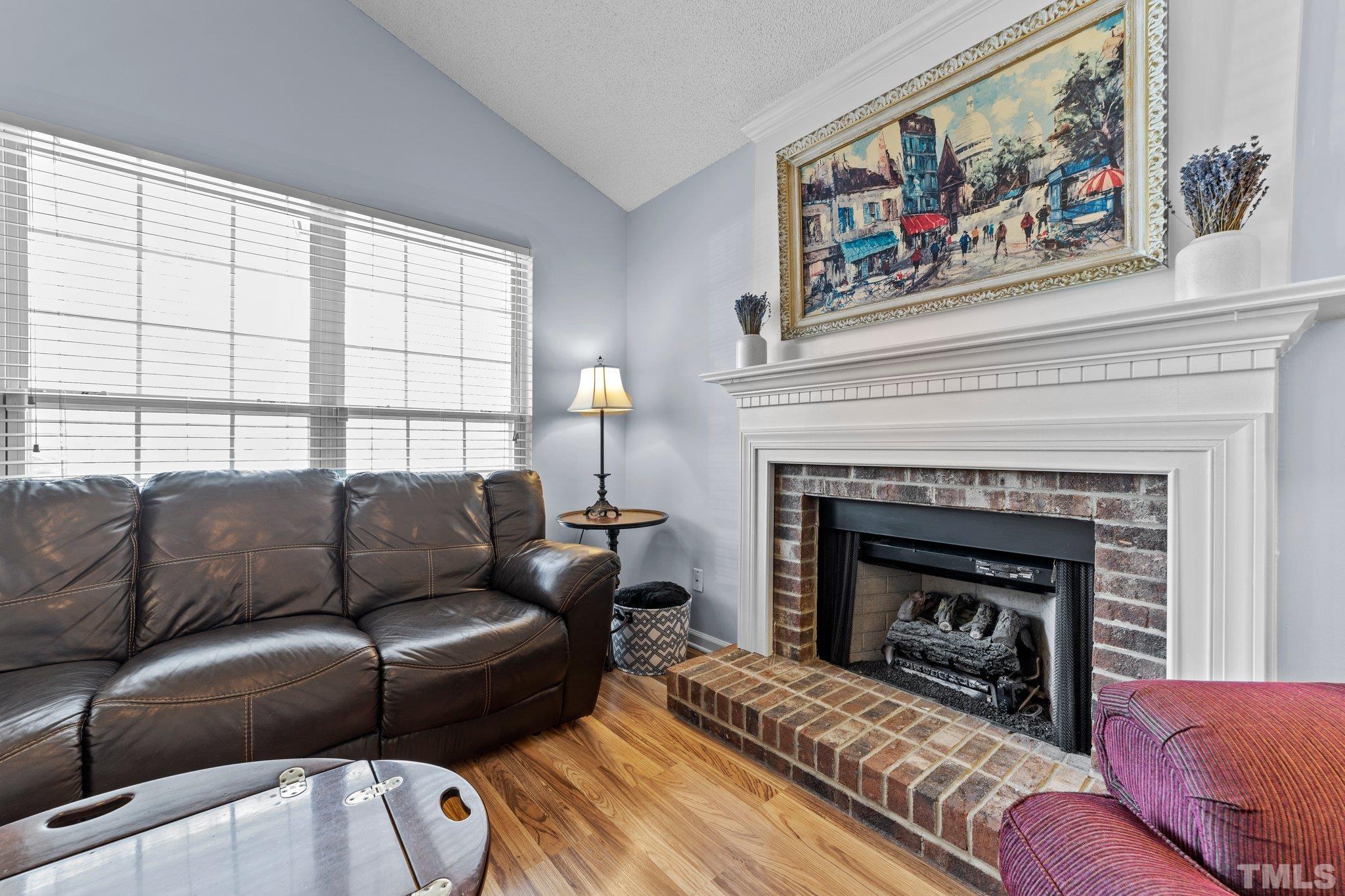 5022 Silhouette Drive Durham, NC 27713 - Photo 4 of 26 a living room with furniture and a fireplace