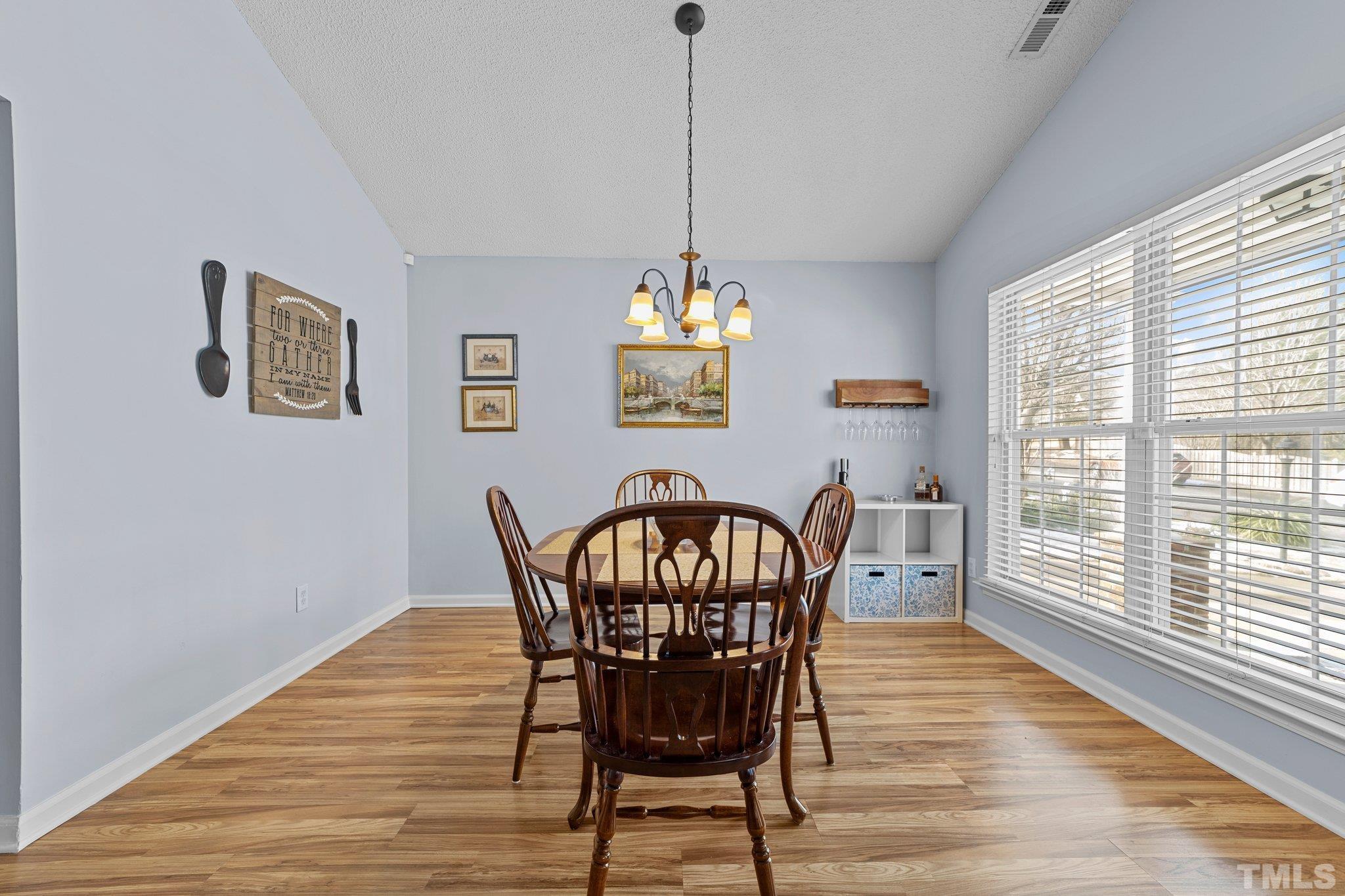 5022 Silhouette Drive Durham, NC 27713 - Photo 7 of 26 a view of a dining room with furniture window and wooden floor