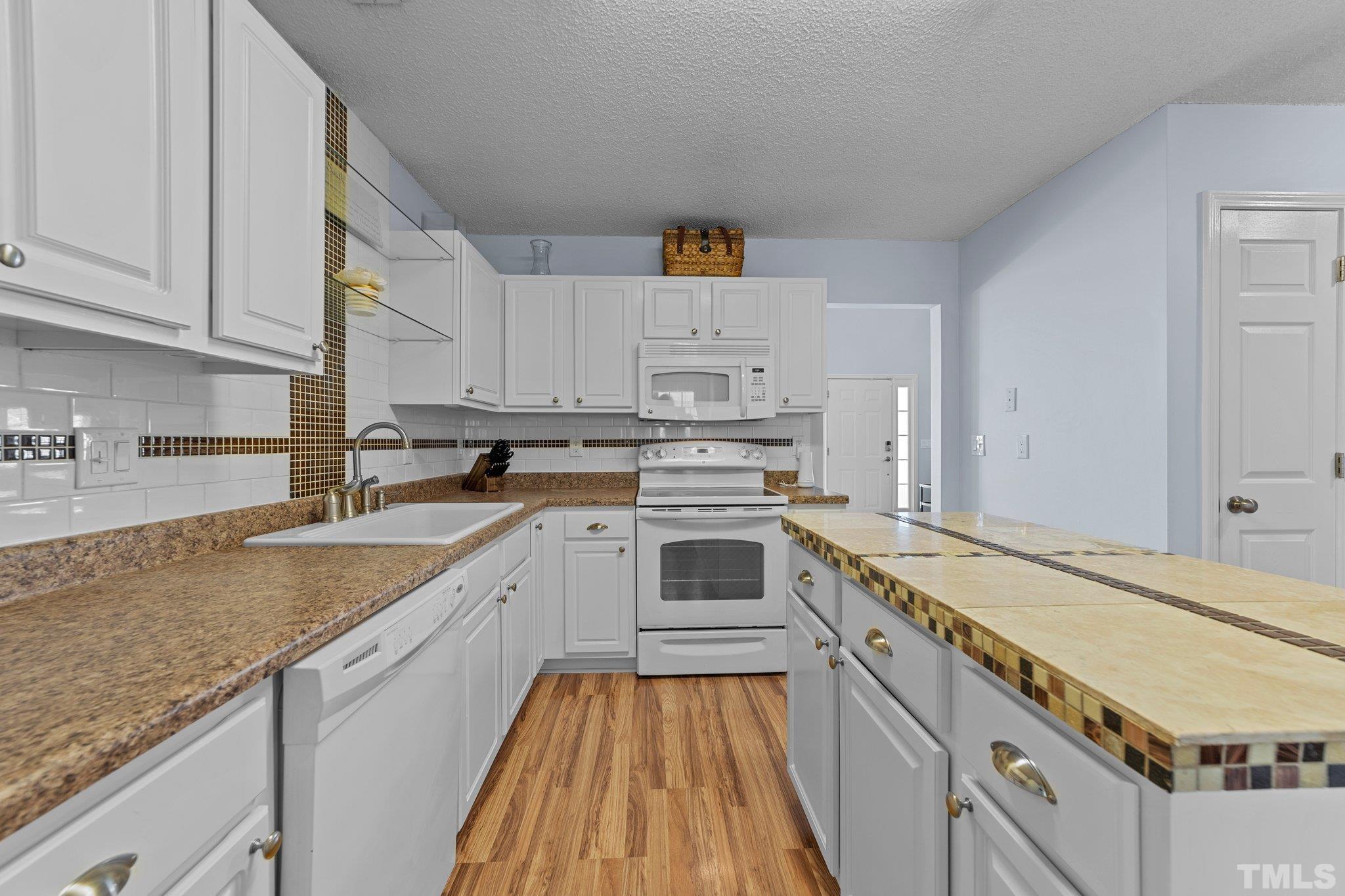 5022 Silhouette Drive Durham, NC 27713 - Photo 9 of 26 a kitchen with stainless steel appliances granite countertop a stove and a sink