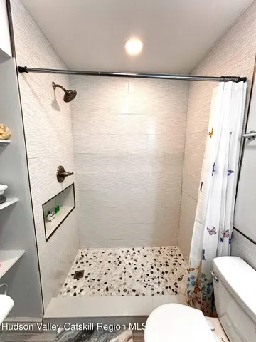 a bathroom with a toilet sink and shower