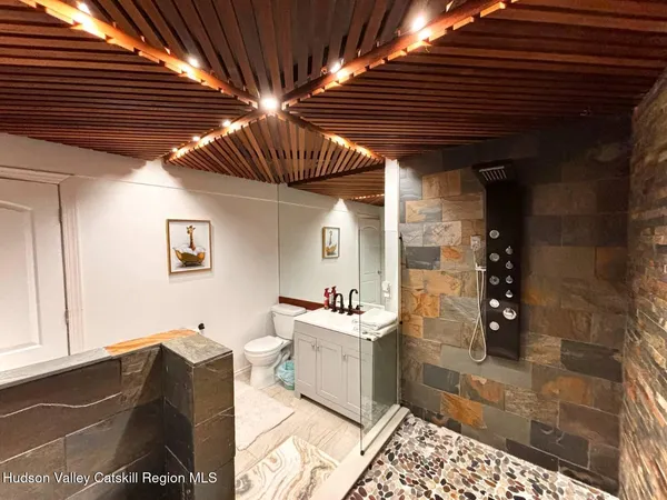 a bathroom with a sink a mirror and a shower