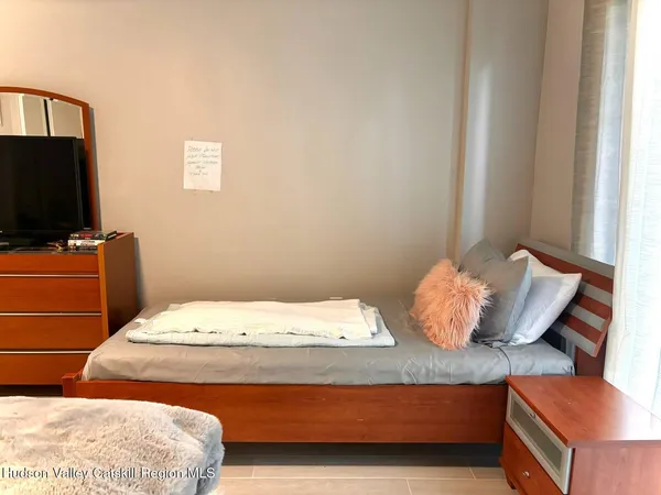 a bedroom with a bed and flat screen tv