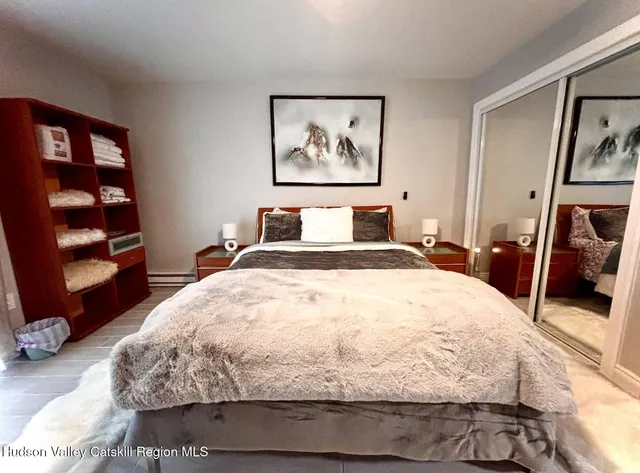 a bedroom with a bed and a walk in closet