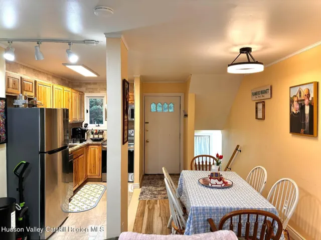 a kitchen with stainless steel appliances granite countertop a dining table and chairs