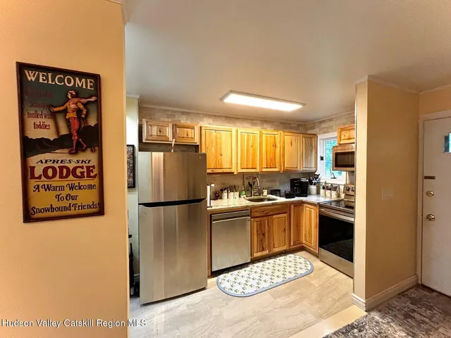 a kitchen with a refrigerator and a sink