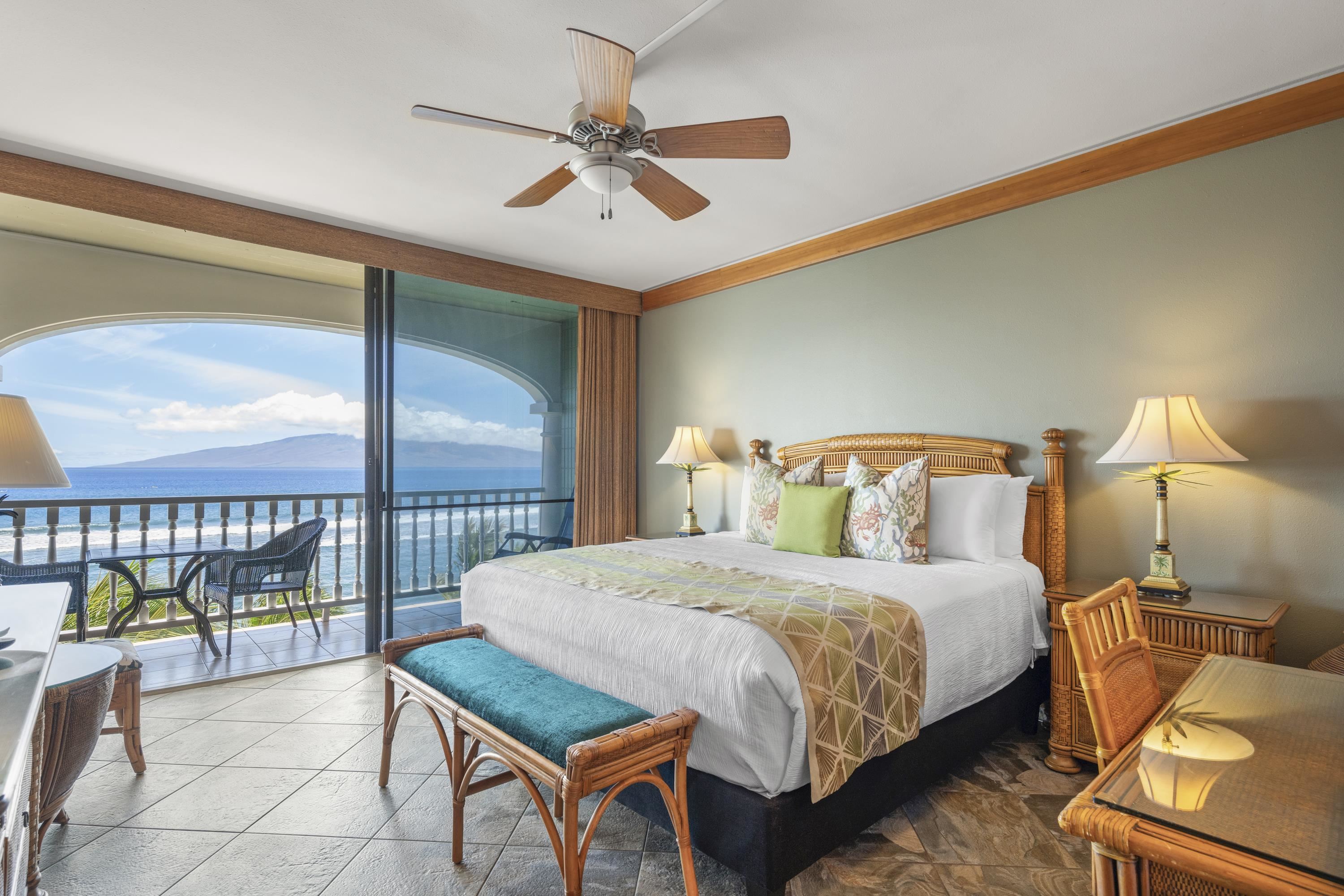 475 Front Street, Unit 601 Lahaina, HI 96761 - Photo 17 of 24 a bedroom with a balcony a bed and a chandelier