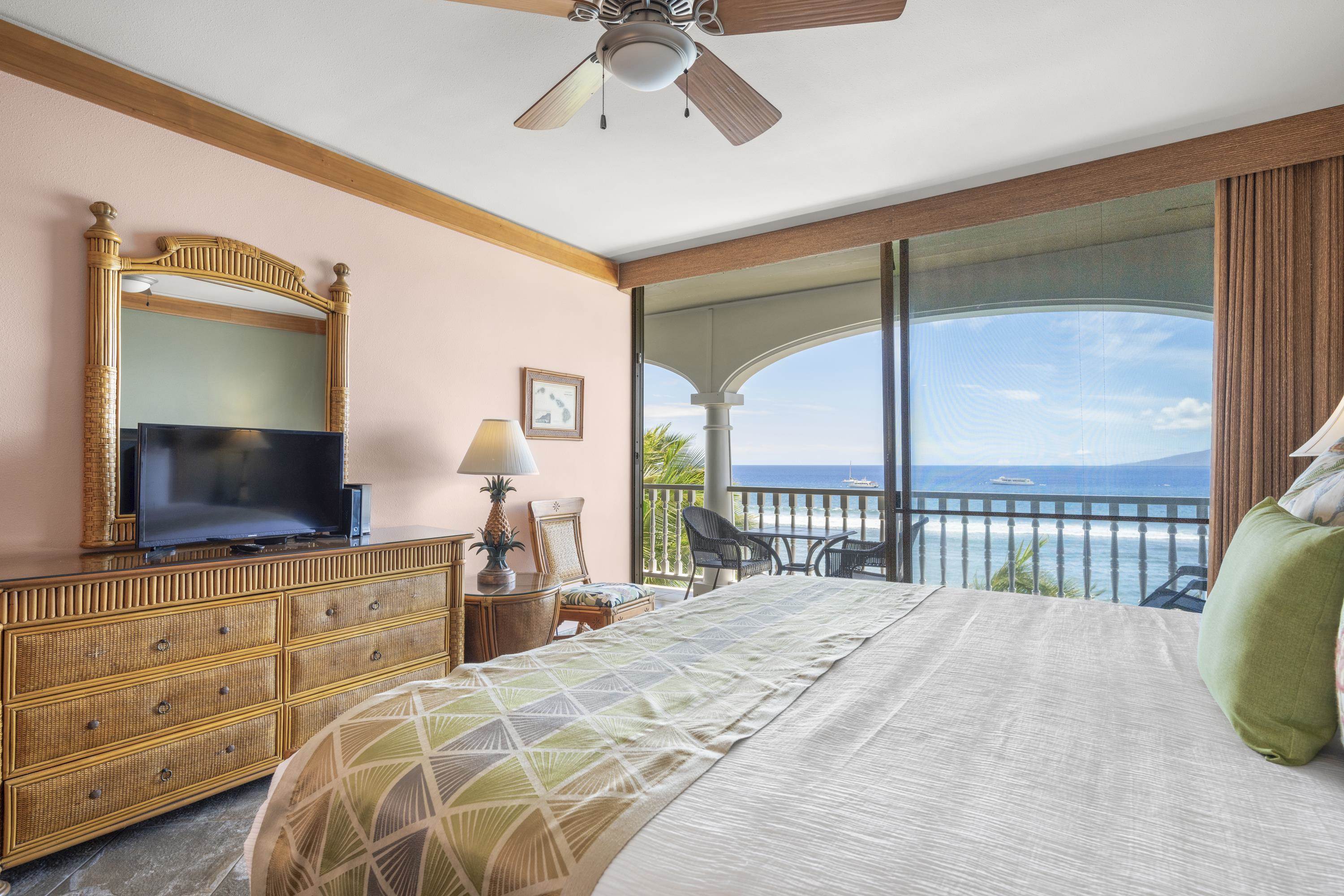 475 Front Street, Unit 601 Lahaina, HI 96761 - Photo 18 of 24 a bedroom with a bed and a flat screen tv
