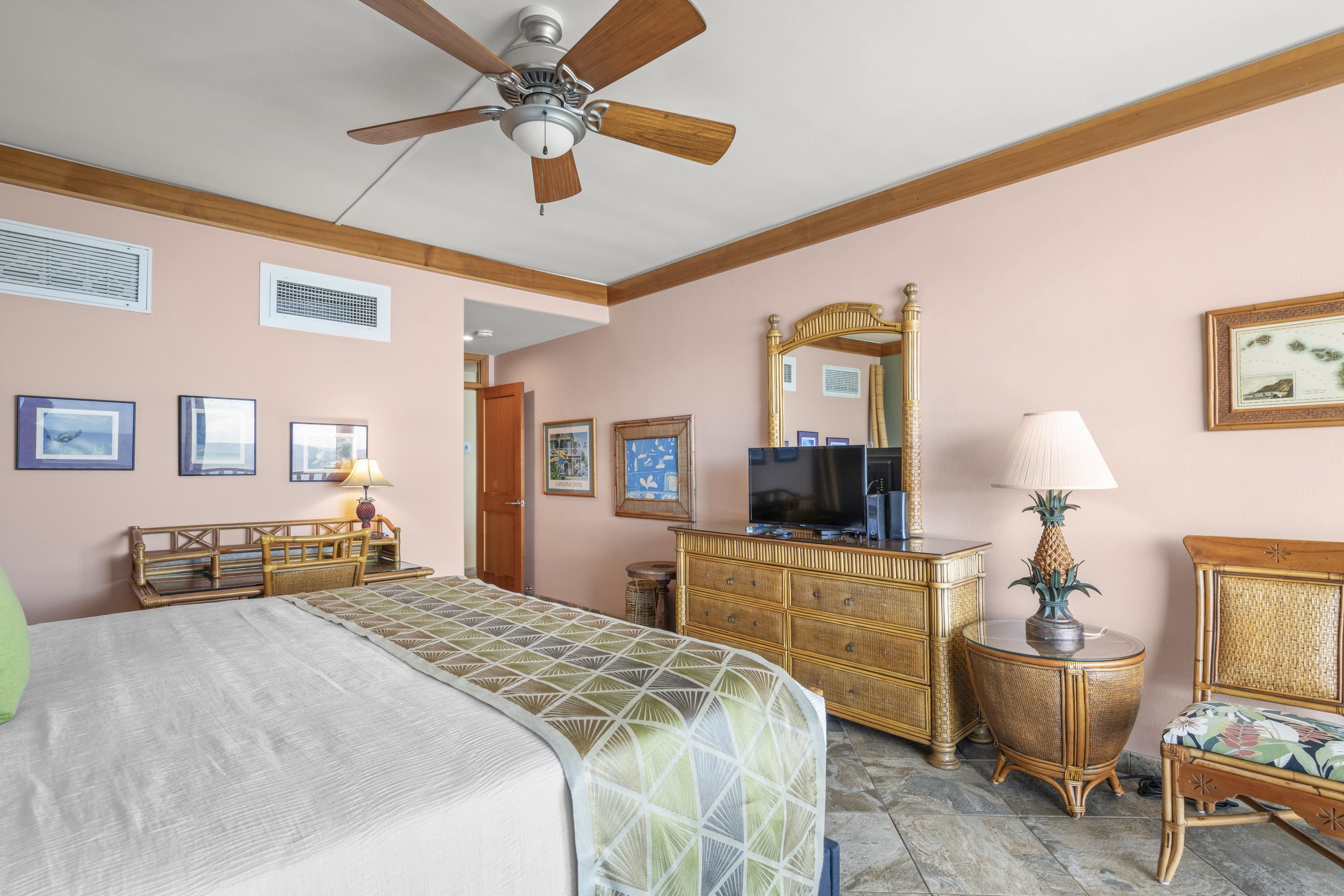 475 Front Street, Unit 601 Lahaina, HI 96761 - Photo 20 of 24 a bedroom with a bed and a chandelier