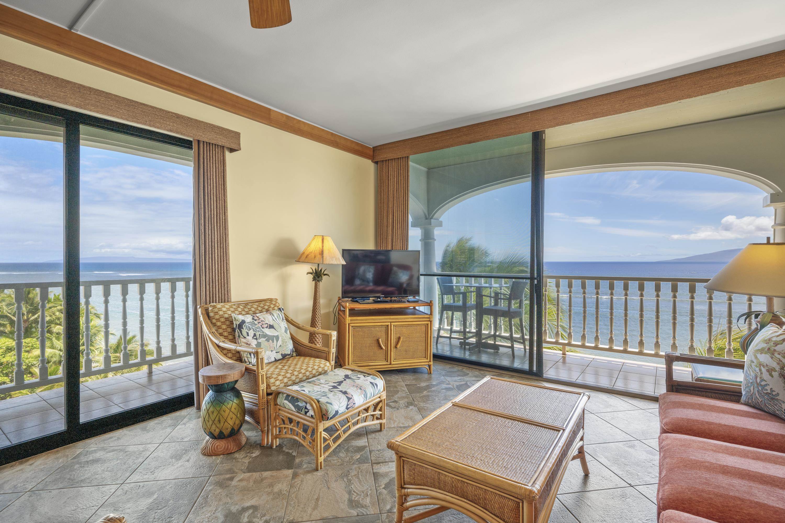 475 Front Street, Unit 601 Lahaina, HI 96761 - Photo 2 of 24 a living room with furniture and a floor to ceiling window