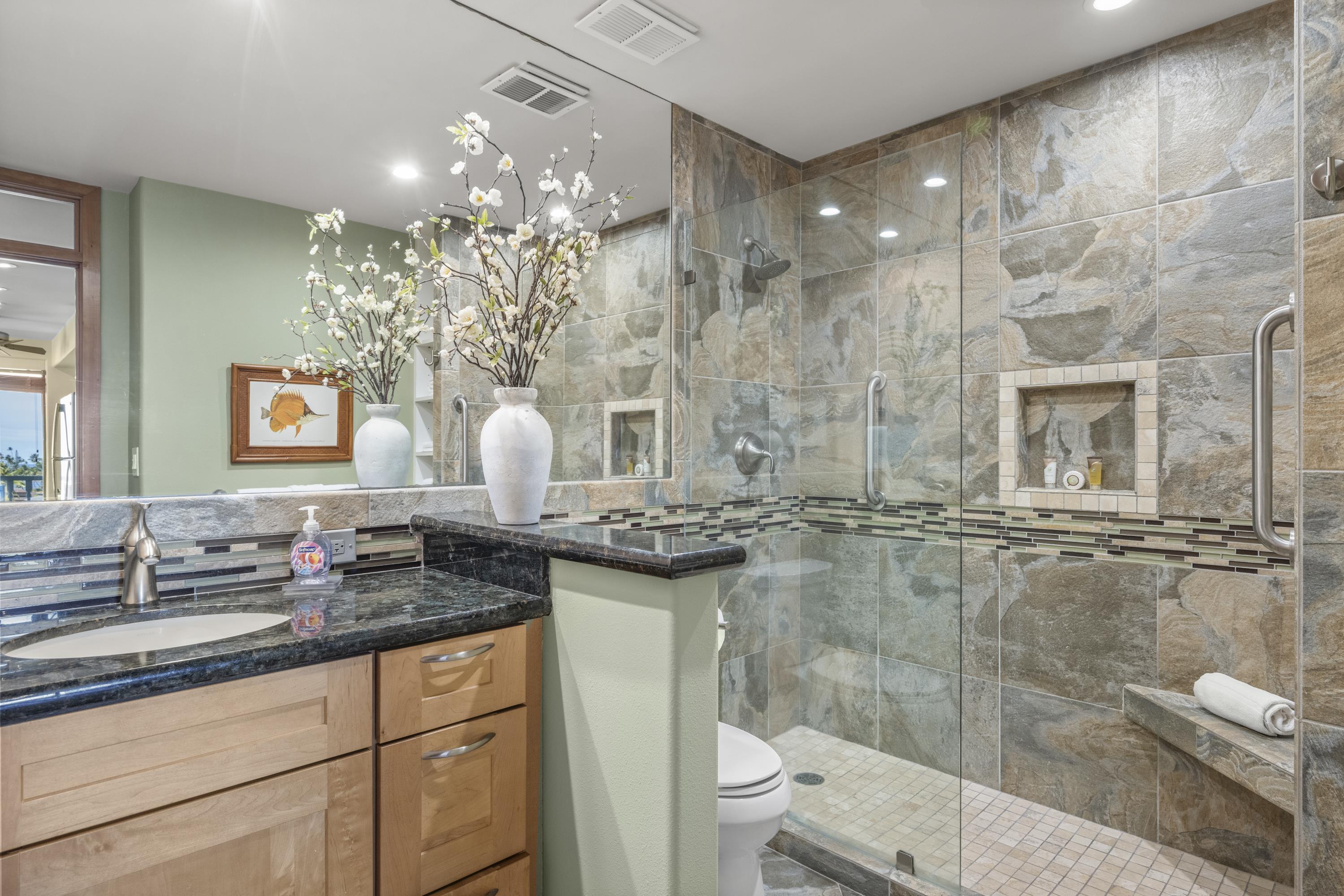 475 Front Street, Unit 601 Lahaina, HI 96761 - Photo 22 of 24 a bathroom with a granite countertop sink a toilet and shower