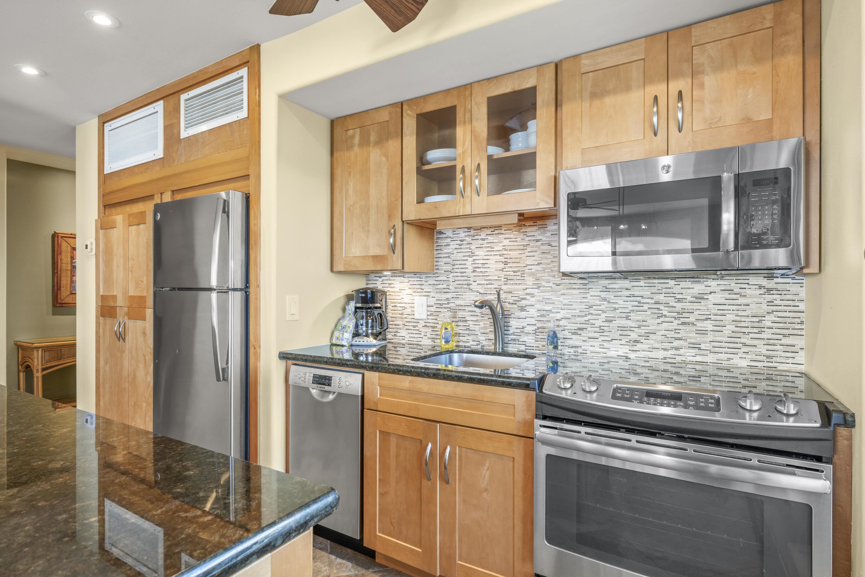475 Front Street, Unit 601 Lahaina, HI 96761 - Photo 7 of 24 a kitchen with stainless steel appliances granite countertop a refrigerator and a sink