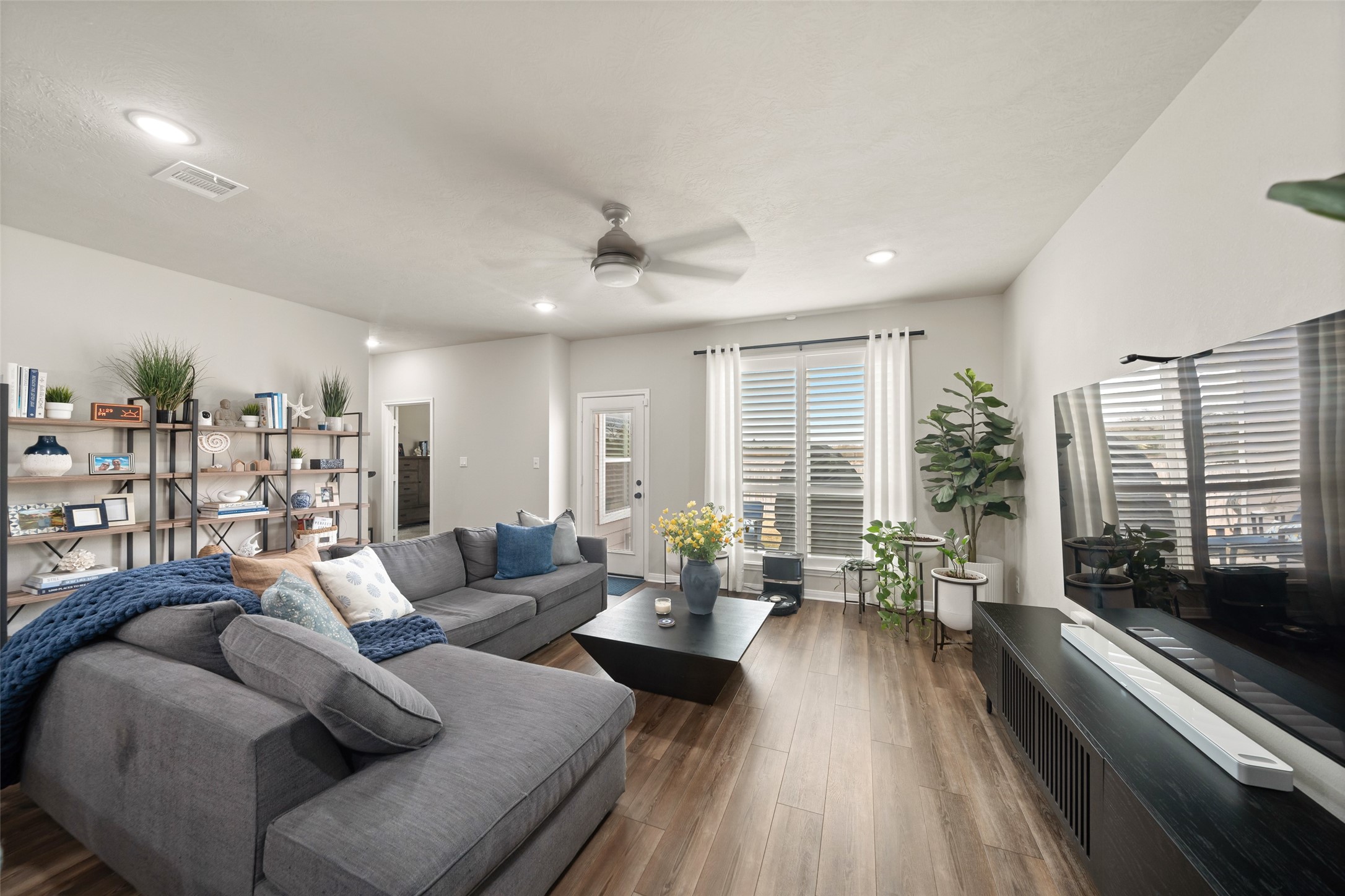1300 Kingsgate Drive Bryan, TX 77807 - Photo 14 of 30 Large living area with plantation shutters and vinyl flooring