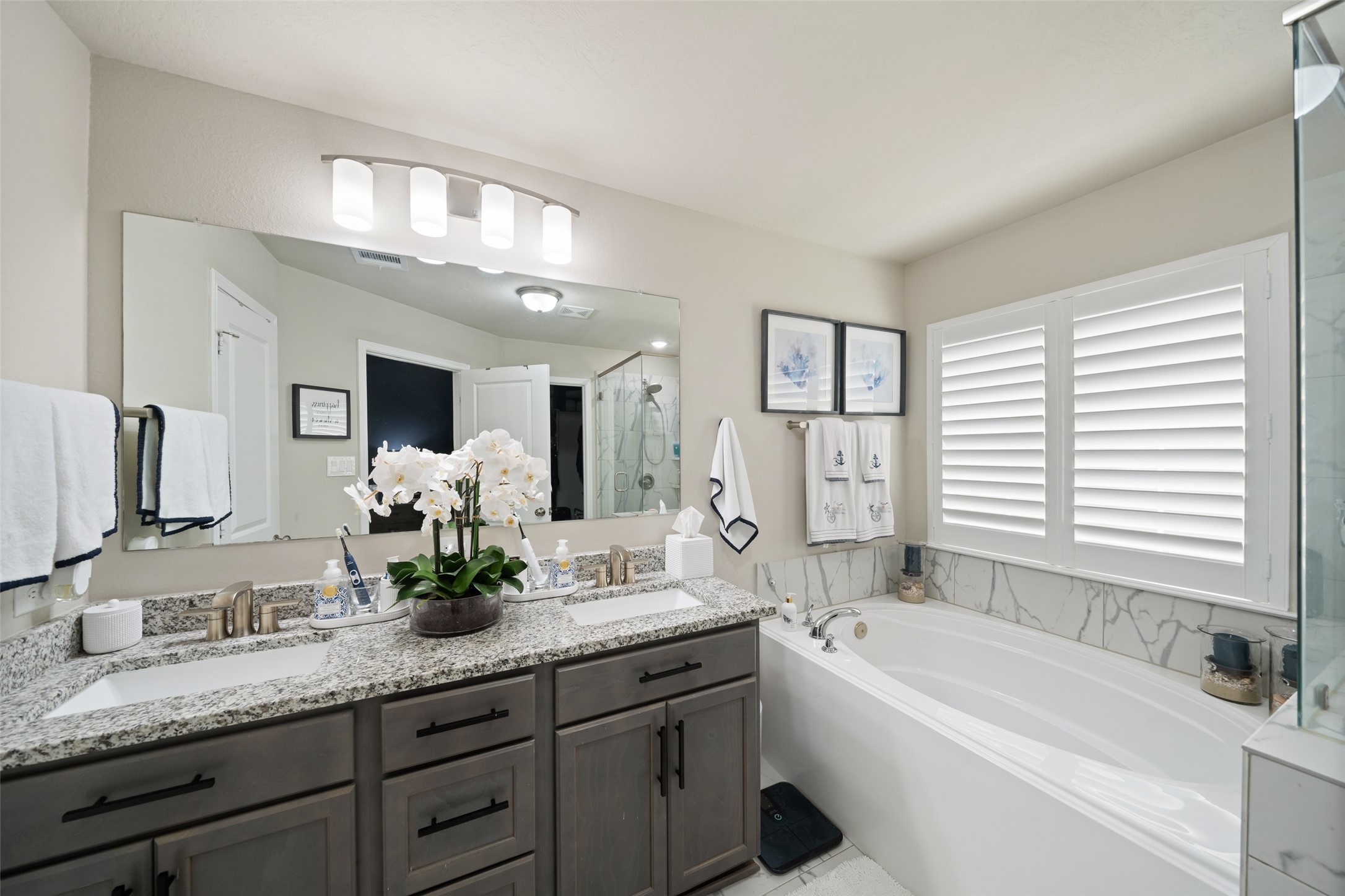 1300 Kingsgate Drive Bryan, TX 77807 - Photo 18 of 30 Primary bath with dual sinks and separate soaking tub. Large drawers for extra storage