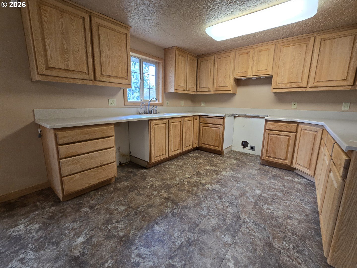 2633 42nd Avenue Longview, WA 98632 - Photo 13 of 32 a kitchen with cabinets appliances and a window