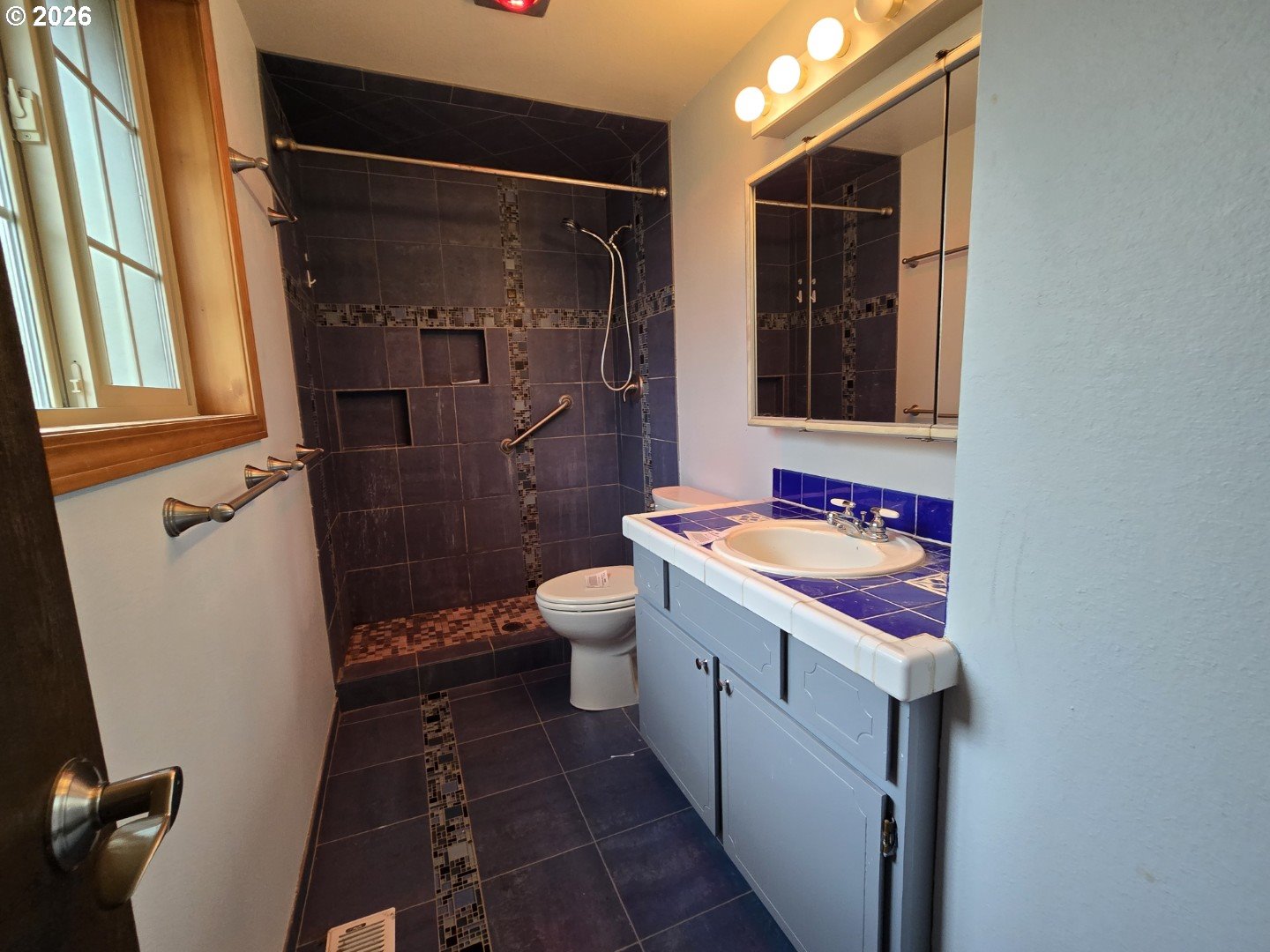 2633 42nd Avenue Longview, WA 98632 - Photo 21 of 32 a bathroom with a sink a toilet and shower