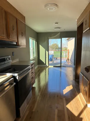 a kitchen with stainless steel appliances granite countertop a stove a sink and a refrigerator