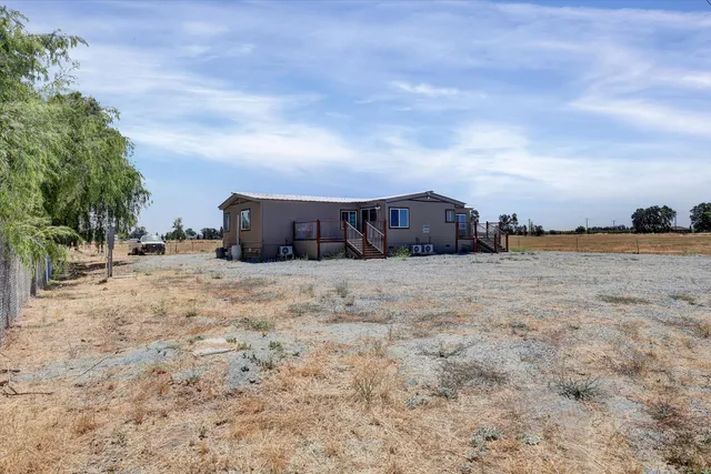 a view of large house with a big yard and covered with trees