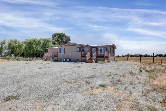 a view of a house with wooden fence