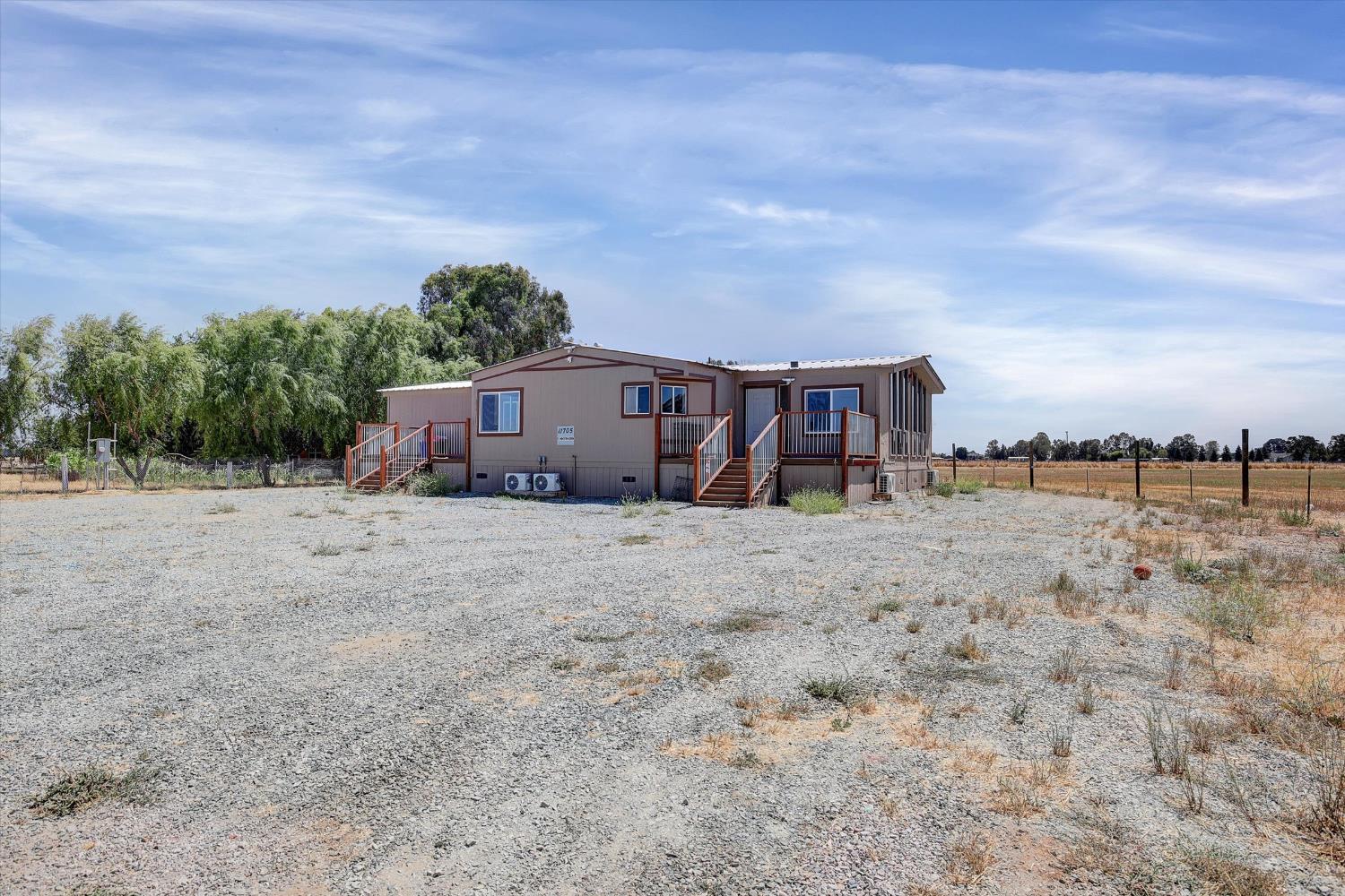 11705 Simmerhorn Road Galt, CA 95632 - Photo 23 of 39 a view of a house with wooden fence