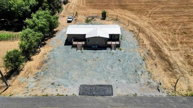 a view of a patio with table and chairs and potted plants