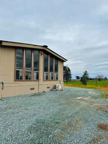 a view of a house with a swimming pool and a yard