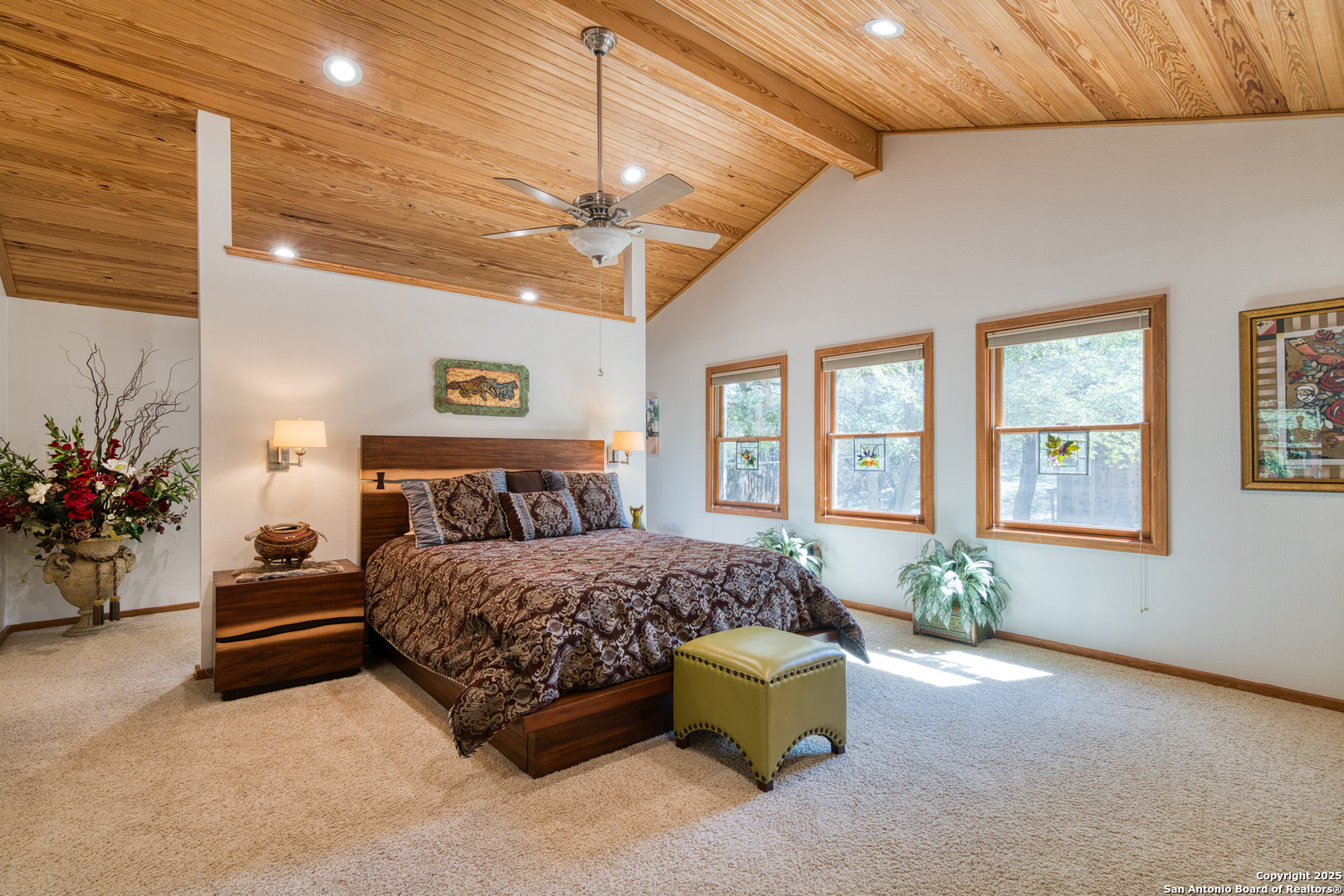 412 Field Road Fischer, TX 78623 - Photo 15 of 42 a spacious bedroom with a bed couch chandelier and windows