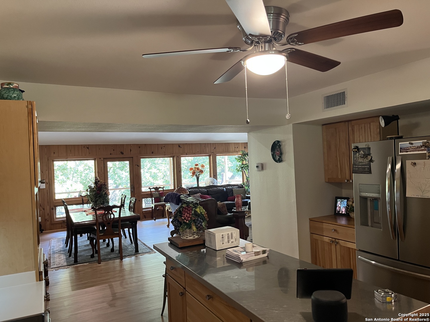 412 Field Road Fischer, TX 78623 - Photo 29 of 42 a kitchen with stainless steel appliances granite countertop a refrigerator a sink a stove and chairs with wooden floor