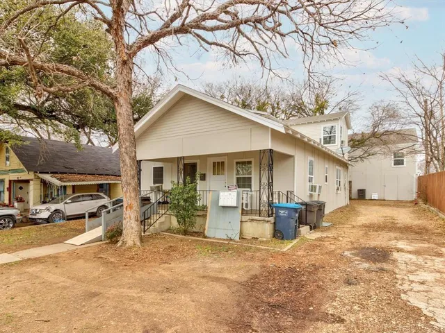 a view of a house with a yard covered in snow
