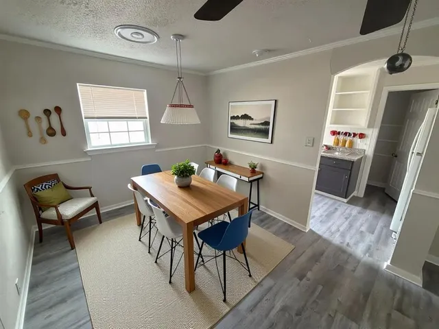a view of a dining room with furniture and wooden floor
