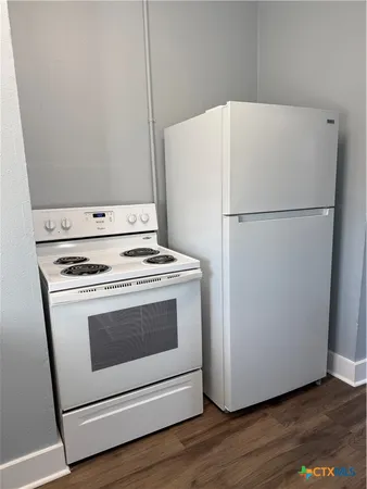 a kitchen with appliances cabinets and a sink