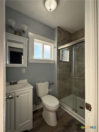 a bathroom with a toilet sink and shower